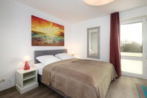 a bedroom with a large bed and a window at Promenade 18 Strandkrabbe in Stakendorfer Strand