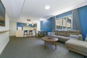a living room with a couch and a table at Spacious One-Bedroom or Studio with Balcony in Sydney