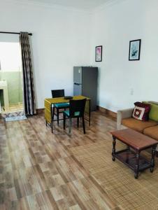 a living room with a table and chairs and a couch at UCS GUESt HOUSE in Siem Reap