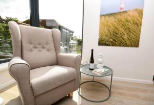 a living room with a chair and a table at Heimathafen Dahme in Dahme