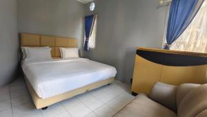 Postel nebo postele na pokoji v ubytování Villa Dalia Puncak H11-5