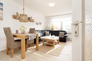 a living room with a table and a couch at Haus Wiking- Nordstern in Grömitz