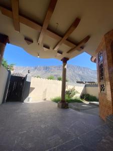 a porch of a house with a view of the desert at Raheel house in Dargai