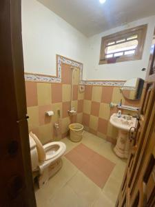 a bathroom with a toilet and a sink at Raheel house in Dargai