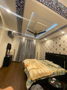 a bedroom with a bed and a ceiling at Raheel house in Dargai