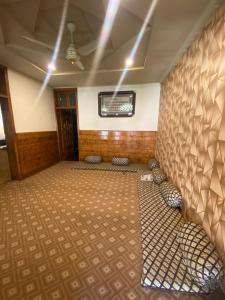 an empty room with a wall with a carpet at Raheel house in Dargai