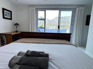 a bedroom with a large bed with a large window at Casa Finchette rooftop apartment with panoramic views of Table Mountain in Cape Town
