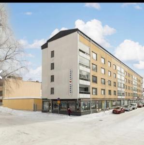 a building with a person standing in front of it at Premium City Center 2 rooms Apartment Glassed Balcony FREE PRIVATE PARKING in Kemi