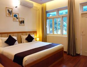 Postel nebo postele na pokoji v ubytování Maashpi Hotel & Resort, Candolim