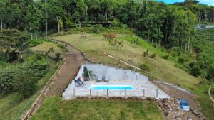 an aerial view of a swimming pool on a hill at Green Cottage Chamarel in Chamarel