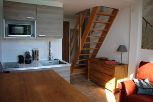 a kitchen with a sink and a kitchen with a staircase at La Sousta in La Colle-sur-Loup