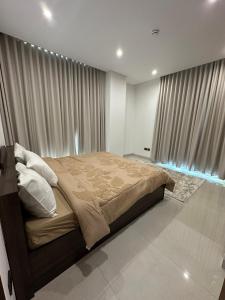 a bedroom with a large bed in front of a window at Sea & Lagoon View in The Wave in Muscat