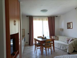 a living room with a table and a couch at G&B Apartments in Tignale