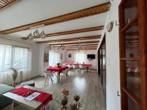 a living room with red tables and chairs at Vila Monica in Bran