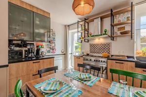 a kitchen with a wooden table with chairs and a dining room at Maison 8 pers plein centre ville in Lesneven +20 photos