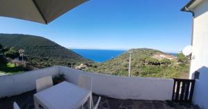 a balcony with a table and a view of the ocean at Sunset House in Mortigliano