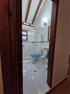 a bathroom with a toilet and a sink at villa sandaned in Villa de Leyva