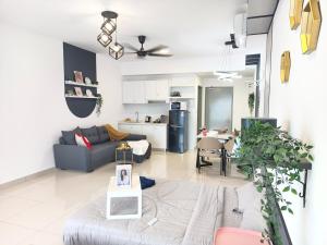 a living room with a couch and a kitchen at TR12 tulip elmina 5pax Big cinema movie 1 free parking in Shah Alam
