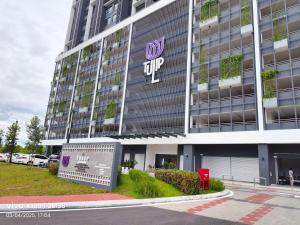 a large building with the top sign on it at TR12 tulip elmina 5pax Big cinema movie 1 free parking in Shah Alam