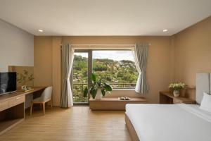 Ένα ή περισσότερα κρεβάτια σε δωμάτιο στο Gold View Boutique Hotel Đà Lạt