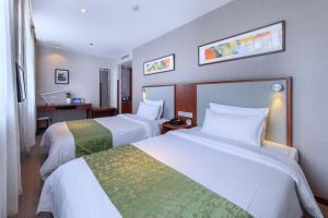 a hotel room with two beds and a desk at Yitel Beijing Tuanjiehu Metro Station in Beijing +251 photos