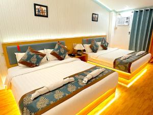 Postel nebo postele na pokoji v ubytování Royal Park Resort Boracay