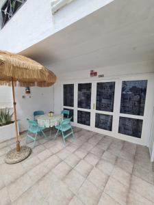 a patio with a table and chairs and an umbrella at Casa Eowyn in Puerto del Carmen