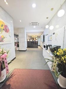 an empty lobby with flowers and plants in a store at Boutiquehotel K Ilsan in Goyang