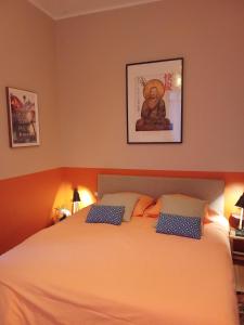 a bedroom with a large white bed with two pillows at Eole in Lacanau-Océan