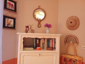 a white book shelf with books and a mirror at Eole in Lacanau-Océan