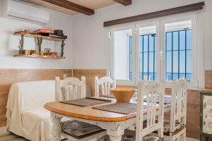 a dining room with a wooden table and chairs at Villa Buganvilla en Salobreña in Salobreña