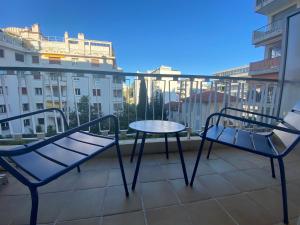 a balcony with a table and chairs on a balcony at L'Astrolabe - Studio - refurbished - seaside in Cannes