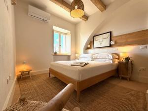 a bedroom with a large bed in a room at Conti di San Bonifacio - Tuscan Townhouse in Montemassi