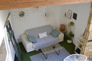 a living room with a couch and a table at La Cachette in Aigues-Vives