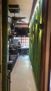a hallway with green walls in a restaurant at AV Dormitory in Rourkela