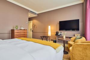 TV a/nebo společenská místnost v ubytování ARQ Paleis Hotel