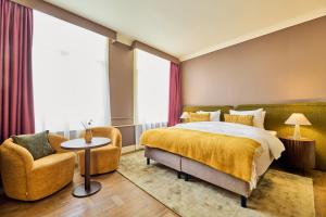 Postel nebo postele na pokoji v ubytování ARQ Paleis Hotel