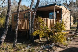 a log cabin in the woods with trees at Camping Liberté Verdon in Artignosc-sur-Verdon