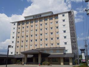a large hotel building with a sign on it at Route Inn Grantia Himi Wakuranoyado in Himi