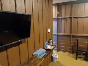 a room with a large flat screen tv on a wall at หาดกำนันแคมป์ปิ้ง&ซีฟู๊ด in Ban Laem Sui