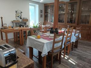a dining room with a table and chairs in a kitchen at A la Ferme de Saint Germain in Saint-Germain-le-Gaillard