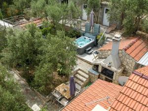 an overhead view of a backyard with a swimming pool on a roof at Stone House Blaca - Two Bedroom Stone House with Terrace and Sea View in Blato