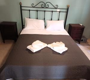 a bed with two towels on top of it at TheOldHouse Seaview in Corfu