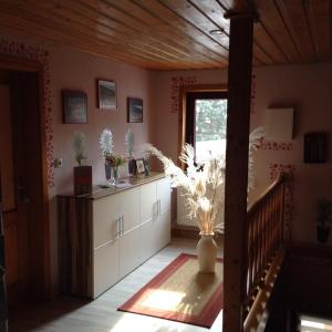 a kitchen with white cabinets and a window at Ferienwohnung Dietlinde in Bad Blankenburg