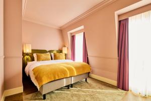 a bedroom with a bed and a window at ARQ Paleis Hotel in The Hague