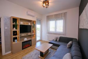 a living room with a couch and a fireplace at White Diamond in Palić