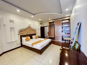 1 dormitorio con cama, escritorio y escalera en Horizon Sea View Apartments, en Mombasa