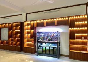 a living room with a tv in a room with wooden walls at Catimor Hotel in Sầm Sơn