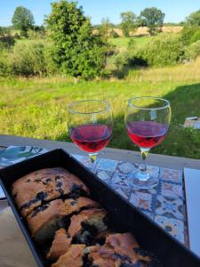 two glasses of red wine and a loaf of bread at Dzika Warmia- domek bez sąsiadów na Warmii z balią i kominkiem in Glebisko