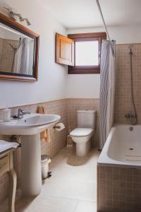 a bathroom with a sink and a tub and a toilet at Casa rural en plena naturaleza, playa, senderismo in Villahormes +56 photos